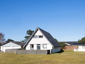 A single-story house with a gabled roof, a front door, and a small porch.