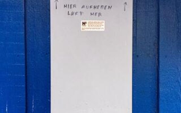 A white sign with text on a blue background, possibly indicating room or hotel information. - 10 Person Holiday Home in Albaek (Aalbaek)