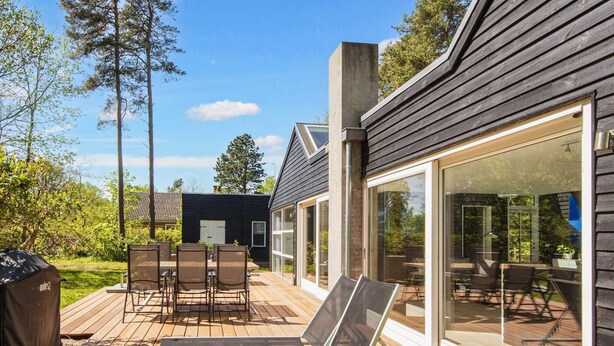 A modern house with a deck, outdoor furniture, and large windows. - 8 Person Holiday Home in Glesborg-by Traum (Glesborg)