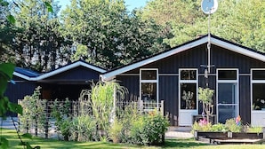 A two-story building with a dark exterior, large windows, and a satellite dish on the roof. - 4 Star Holiday Home in Saeby (Sæby)