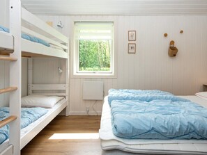 A bunk bed room with a window, a radiator, and wall decorations. - 8 Person Holiday Home in Hemmet (Hemmet)