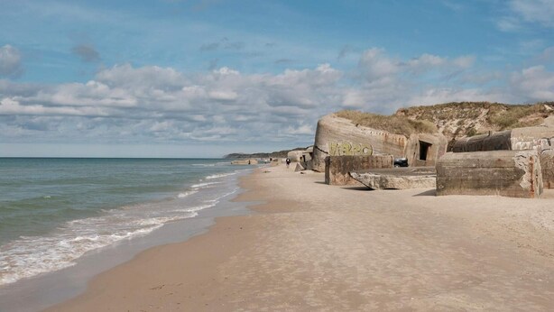 A beach with large concrete structures, a sandy shore, and the ocean. - 4 Star Holiday Home in Lokken (Lokken)