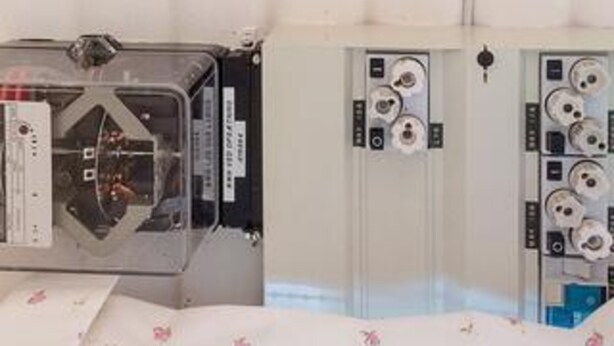 A room with a bed, a bedside table, and a wall-mounted control panel. - Ideal Holiday Home in Stege near Sea (Stege)