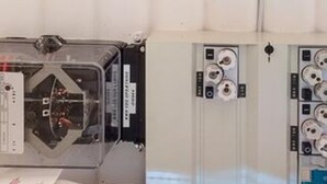 A room with a bed, a bedside table, and a wall-mounted electrical panel. - Ideal Holiday Home in Stege near Sea (Stege)