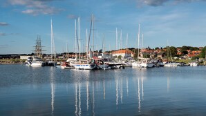 A marina with various boats docked, calm water, and a town in the background. - 4 Person Holiday Home in Ebeltoft-by Traum (Ebeltoft)