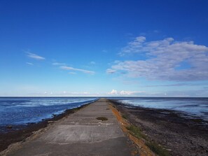 A concrete pathway leading to the ocean with a clear sky above. - Serene Holiday Home in Hadsund near Sea (Hadsund)