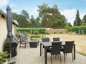 Enjoy al fresco dining on the patio with a grill, table, and comfortable seating.