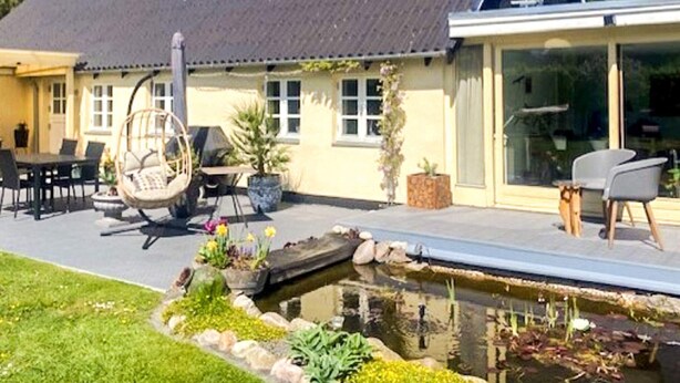 A house with a large patio, a swimming pool, and a garden. - 5 Person Holiday Home in Vig (Vig)