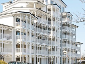 A multi-story building with balconies and large windows. - Holiday Home in Grossenbrode (Grossenbrode)