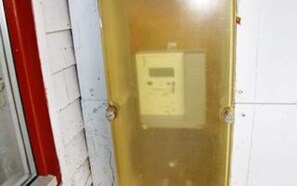 A door with a glass panel and a control panel inside.