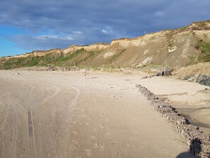 A sandy beach with footprints and a wooden fence. - 5 Star Holiday Home in Lokken (Lokken)