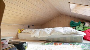 A small, wooden-paneled room with a single bed, a desk with a computer, and a window. - 5 Star Holiday Home in Rodby (Rodby)