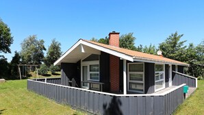 A small house with a fenced backyard, a chimney, and a satellite dish. - 5 Star Holiday Home in Hadsund (Hadsund)