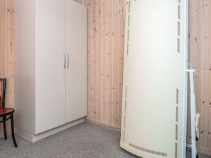 A room with a wardrobe, a chair, and a white cabinet. - Secluded Holiday Home in Henne near Beach (Henne)