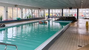 An indoor swimming pool with clear water, tiled floor, and a lifeguard station. - 5 Star Holiday Home in Ringkobing (Ringkobing)