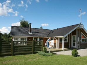 A building with a sloped roof, a chimney, and a satellite dish on the roof. - 5 Star Holiday Home in Vaeggerlose (Vaeggerlose)