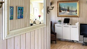 A room with wooden paneling, a large mirror, a painting, a desk with a computer, and a chair. - Cozy Holiday Home in Læsø near Sea (Læsø)