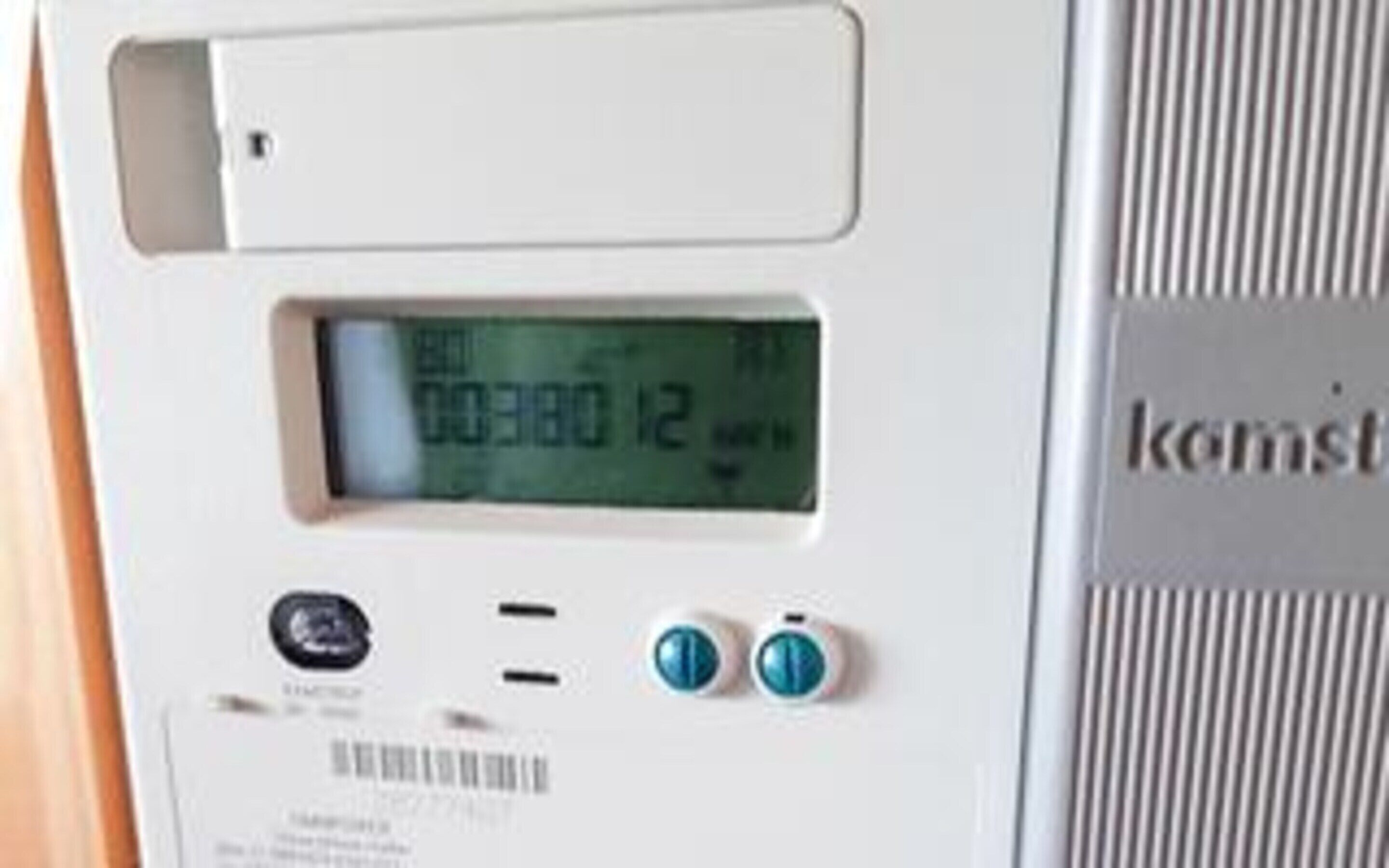 A digital display on a device with a barcode and two buttons below it.