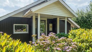 A building with a covered porch, a satellite dish, and a window. - 5 Star Holiday Home in Tarm (Tarm)