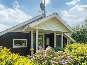 A building with a covered porch, a satellite dish, and a window. - 5 Star Holiday Home in Tarm (Tarm)