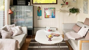 A cozy living room with two sofas, a small table, and a kitchen area in the background. - 5 Person Holiday Home in Lemvig (Lemvig)