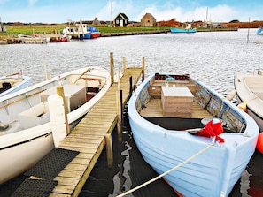 A dock with several boats, a small wooden structure, and a grassy field in the background. - Peaceful Holiday Home in Jutland near Sea (Hvide Sande)