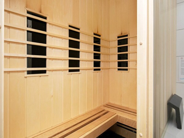 A sauna with wooden walls and benches. - 5 Star Holiday Home in Brovst (Brovst)