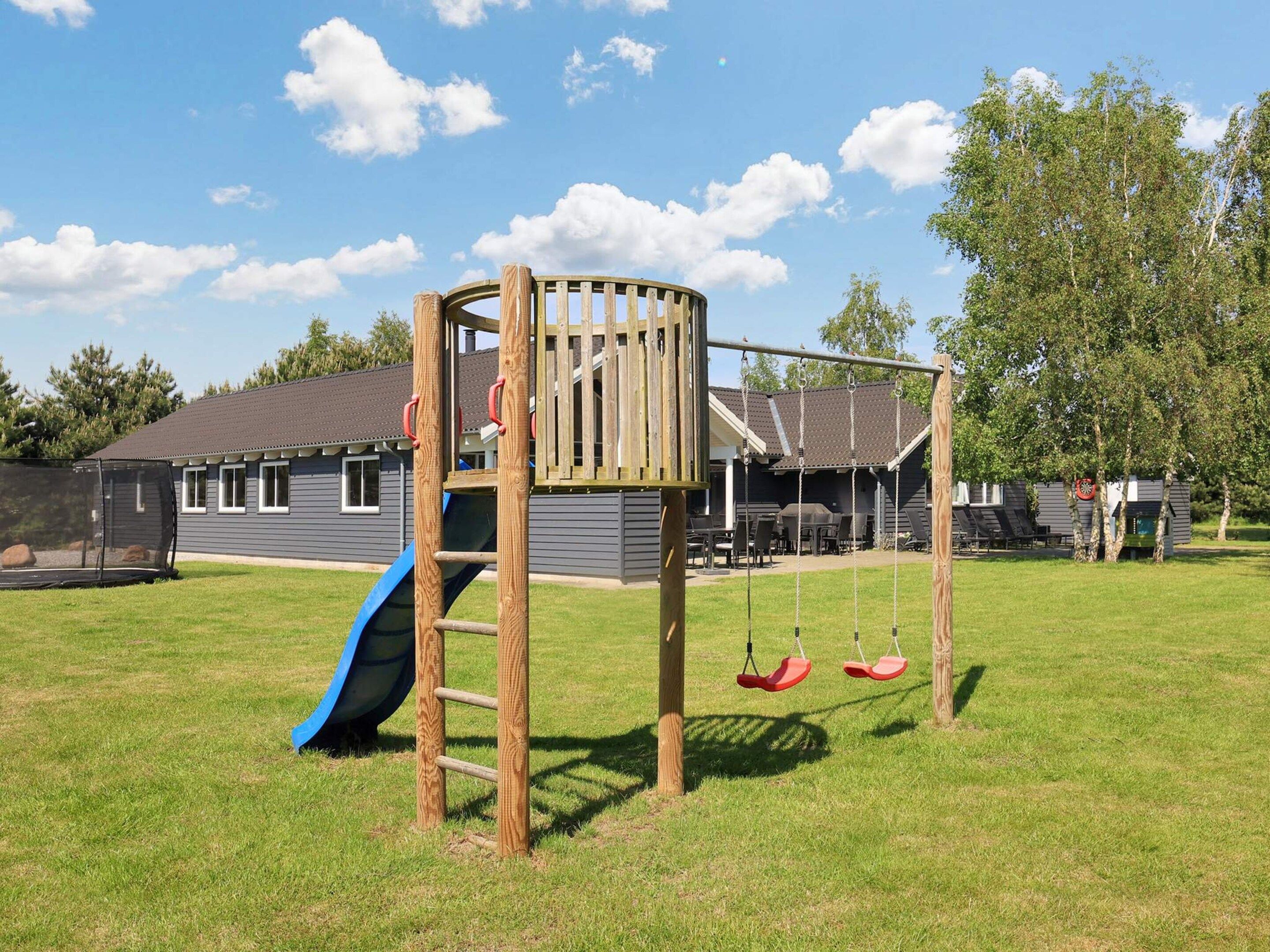 A playground with a slide, swings, and a climbing structure.