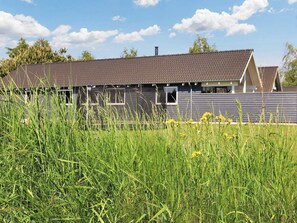 A building with a sloped roof, a visible chimney, and a window. - Luxury Holiday Home in Falster near Sea (Vaeggerlose)