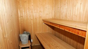 A wooden sauna room with benches and a small table. - 4 Star Holiday Home in Nexo (Nexø)