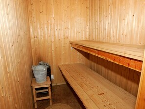A wooden sauna room with benches and a small table. - 4 Star Holiday Home in Nexo (Nexø)