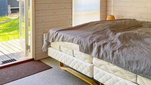 A bedroom with a bed, a window, and a view of the outdoors. - 5 Person Holiday Home in Hemmet (Hemmet)