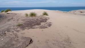 A sandy beach with sparse vegetation and a clear view of the ocean. - Quaint Holiday Home in LÃ¸kken near Beach (Lokken)