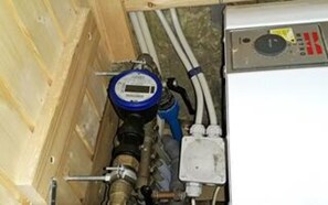 A water meter, pipes, and a control panel in a utility room. - 4 Star Holiday Home in Hemmet (Hemmet)