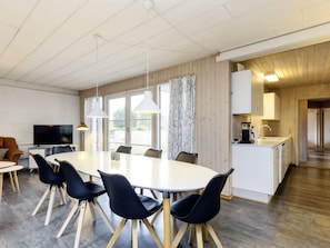 A modern kitchen with white cabinets, a sink, and a countertop.