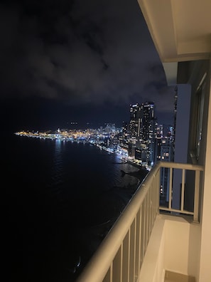 A nighttime cityscape with a view of the water and buildings. - Palmetto Suite Superior 3901 (Cartagena)