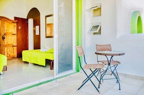 A room with a bed, a chair, a table, a wooden wardrobe, and a door with a number. - Gorgeous 11 People Superior Villa With Pool Playacar Phase 2 (Playa del Carmen)