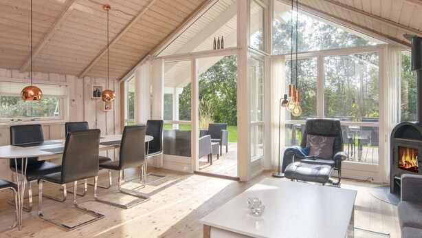 A spacious room with a high ceiling, large windows, and a fireplace. - 6 Person Holiday Home in Hemmet-by Traum (Hemmet)