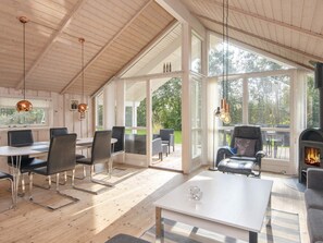 A spacious room with a high ceiling, large windows, and a fireplace. - 6 Person Holiday Home in Hemmet-by Traum (Hemmet)