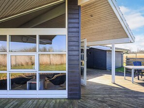 A modern building with large windows and a covered patio area. - 5 Star Holiday Home in Rodby (Rodby)