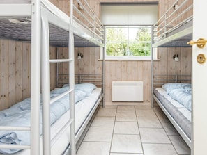 A dormitory room with bunk beds, a window, and a radiator. - 4 Star Holiday Home in Orsted (Ørsted)
