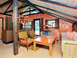A cozy cabin interior with a dining area, seating, and a kitchen. - 6 Person Holiday Home in Rodby (Rodby)