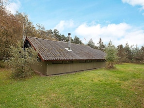 A single-story building with a sloped roof, a chimney, and a small porch. - Holiday Home Escape in Scenic Rodby (Rodby)