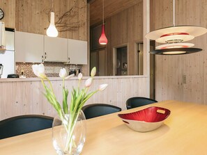 A modern kitchen with wooden cabinets, a tiled backsplash, and pendant lighting. - 5 Star Holiday Home in Vaeggerlose (Vaeggerlose)