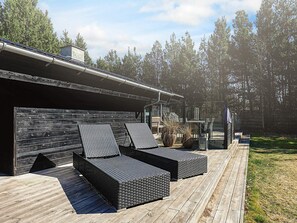 A deck with outdoor seating and a covered area. - 6 Person Holiday Home in Jerup (Jerup)