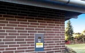 A brick building with a small sign on the wall.