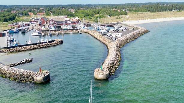A marina with boats docked, a small sailboat in the water, and a beach in the background. - 6 Person Holiday Home in Albaek-by Traum (Aalbaek)