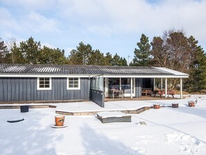 A two-story building with a covered patio area.