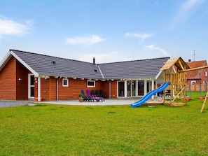 A wooden building with a blue slide and a wooden playhouse. - 5 Star Holiday Home in Sydals (Sydals)