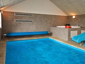 A swimming pool with a blue slide, a bench, and a small sink area. - 5 Star Holiday Home in Sydals (Sydals)